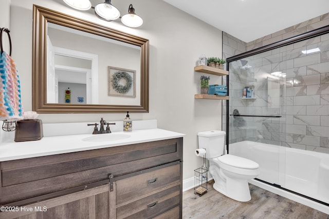 3446 Constable Way, Wilmington, NC 28405 - full bathroom featuring wood finished floors, a shower with door, vanity, toilet, and baseboards