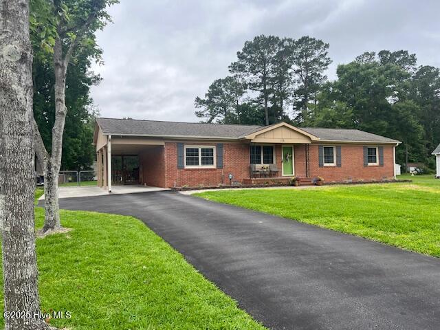 115 Oak Hills Dr, Rocky Point, NC 28457 - ranch-style home with an attached carport, a front lawn, brick siding, and asphalt driveway