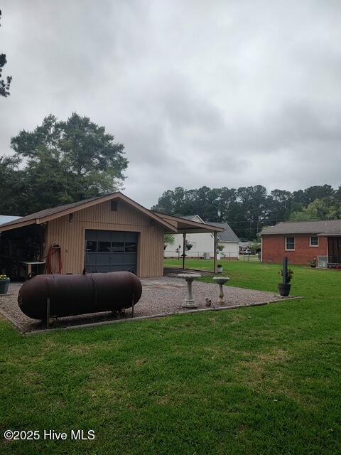 115 Oak Hills Dr, Rocky Point, NC 28457 - view of grassy yard featuring an attached garage and an outbuilding