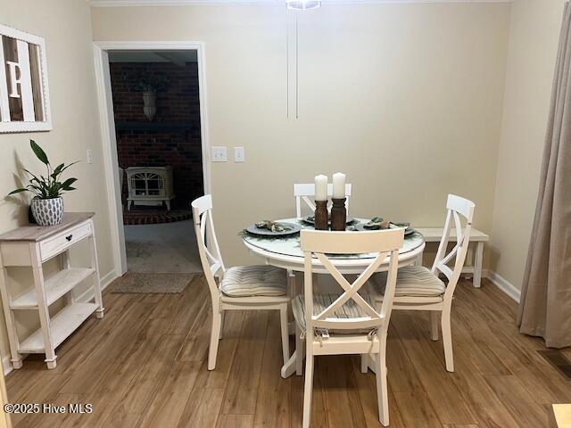 115 Oak Hills Dr, Rocky Point, NC 28457 - dining space featuring light wood-style floors and a wood stove
