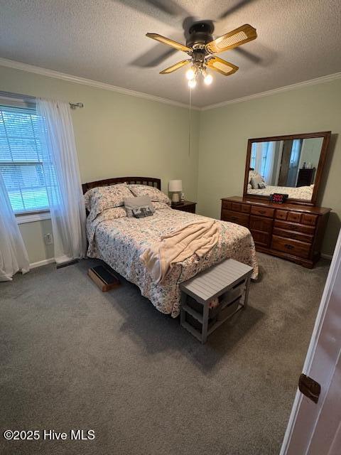 115 Oak Hills Dr, Rocky Point, NC 28457 - carpeted bedroom featuring crown molding, a textured ceiling, and a ceiling fan
