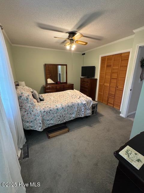 115 Oak Hills Dr, Rocky Point, NC 28457 - carpeted bedroom with crown molding, a textured ceiling, a closet, and ceiling fan