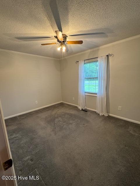 115 Oak Hills Dr, Rocky Point, NC 28457 - spare room featuring a textured ceiling, crown molding, ceiling fan, and dark colored carpet
