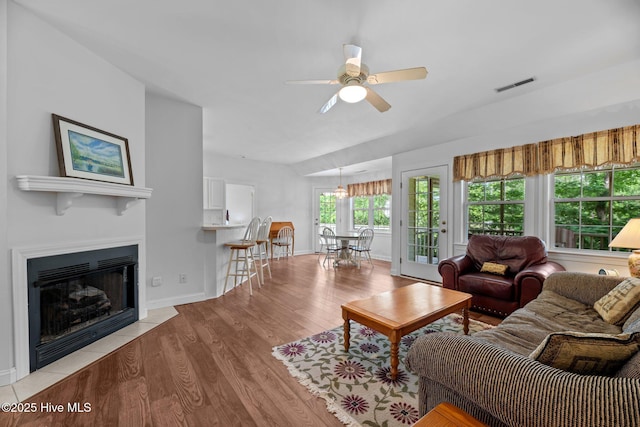 6112 Horton Rd, Oriental, NC 28571 - living room featuring a ceiling fan, light wood finished floors, a fireplace with flush hearth, and baseboards