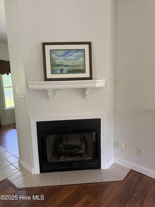 6112 Horton Rd, Oriental, NC 28571 - detailed view of a fireplace with flush hearth, wood finished floors, and baseboards