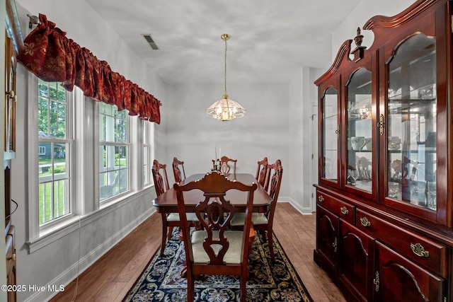 6112 Horton Rd, Oriental, NC 28571 - dining room featuring a chandelier, wood finished floors, and baseboards