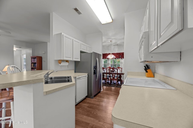 6112 Horton Rd, Oriental, NC 28571 - kitchen featuring a sink, dishwasher, a peninsula, light countertops, and dark wood-type flooring