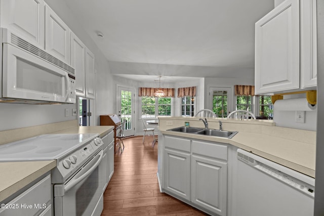 6112 Horton Rd, Oriental, NC 28571 - kitchen featuring white appliances, a sink, dark wood finished floors, a chandelier, and white cabinetry