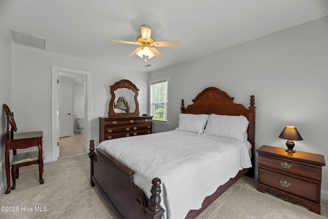 6112 Horton Rd, Oriental, NC 28571 - bedroom with light carpet, baseboards, ceiling fan, and ensuite bath