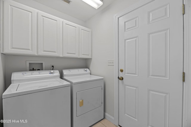 6112 Horton Rd, Oriental, NC 28571 - washroom featuring independent washer and dryer, cabinet space, light tile patterned flooring, and baseboards