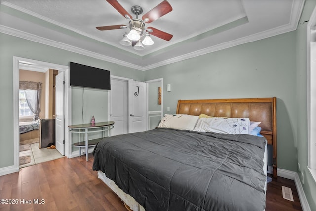 270 N Jenkins St, Holly Ridge, NC 28445 - bedroom featuring wood finished floors, ornamental molding, a ceiling fan, a raised ceiling, and baseboards