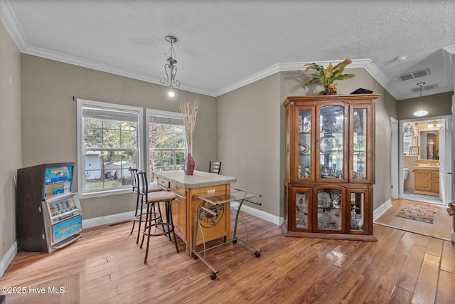 270 N Jenkins St, Holly Ridge, NC 28445 - dining room featuring light wood-type flooring, baseboards, crown molding, and a textured ceiling