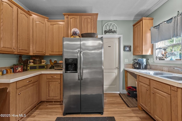 270 N Jenkins St, Holly Ridge, NC 28445 - kitchen featuring stainless steel fridge, light wood-type flooring, a sink, and crown molding