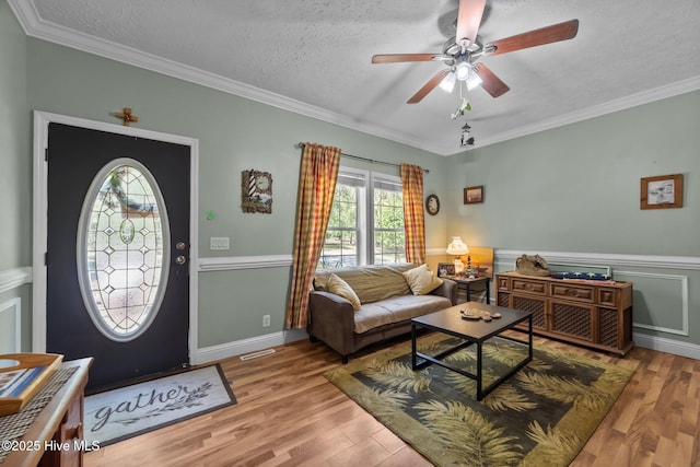 270 N Jenkins St, Holly Ridge, NC 28445 - living area featuring plenty of natural light, wood finished floors, ceiling fan, a textured ceiling, and crown molding