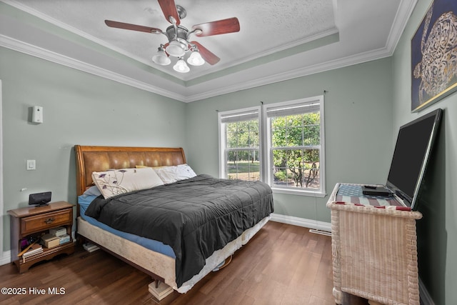 270 N Jenkins St, Holly Ridge, NC 28445 - bedroom with wood finished floors, ornamental molding, a raised ceiling, baseboards, and ceiling fan