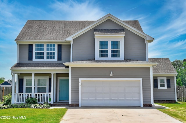 115 Elrod Rd, Moyock, NC 27958 - traditional-style home featuring covered porch, concrete driveway, a garage, fence, and a shingled roof