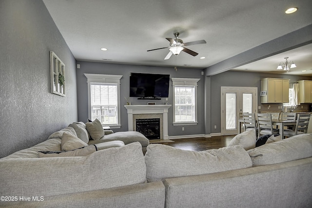 115 Elrod Rd, Moyock, NC 27958 - living area featuring healthy amount of natural light, a ceiling fan, recessed lighting, dark wood finished floors, and a fireplace with flush hearth