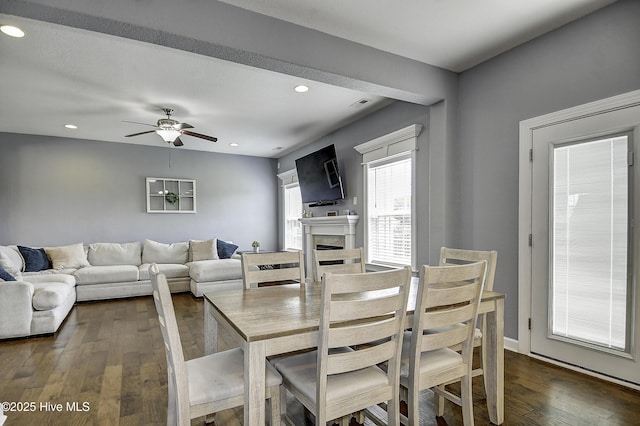 115 Elrod Rd, Moyock, NC 27958 - dining area featuring dark wood-type flooring, a fireplace, recessed lighting, and a ceiling fan