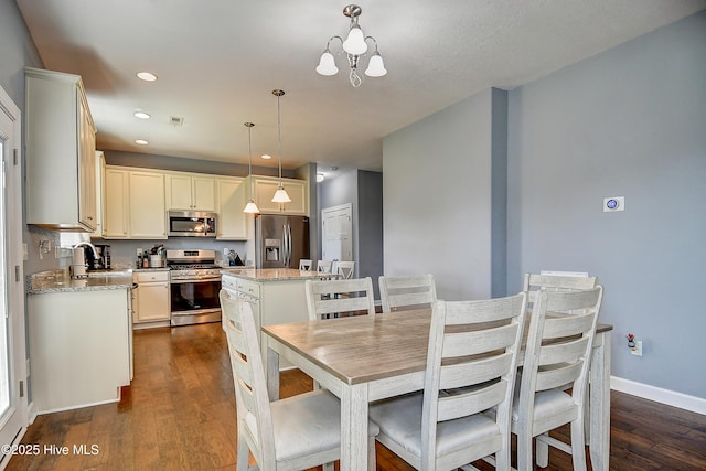 115 Elrod Rd, Moyock, NC 27958 - dining area with dark wood finished floors, a chandelier, baseboards, and recessed lighting