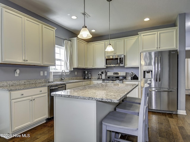 115 Elrod Rd, Moyock, NC 27958 - kitchen featuring stainless steel appliances, a sink, dark wood-style flooring, light stone countertops, and recessed lighting