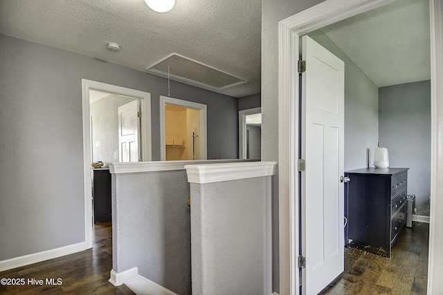 115 Elrod Rd, Moyock, NC 27958 - hall with dark wood finished floors, attic access, baseboards, and a textured ceiling