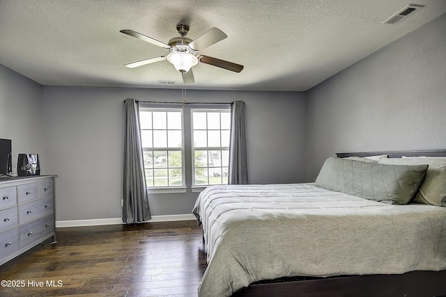 115 Elrod Rd, Moyock, NC 27958 - bedroom featuring a textured ceiling, dark wood-style flooring, baseboards, and a ceiling fan