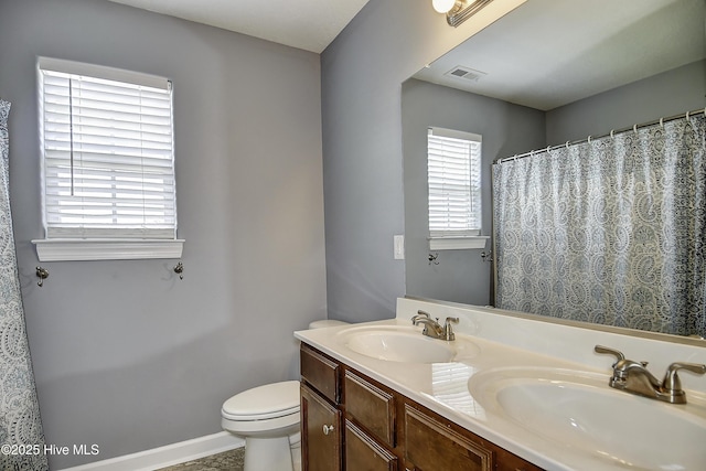 115 Elrod Rd, Moyock, NC 27958 - bathroom with toilet, double vanity, baseboards, and a shower with shower curtain