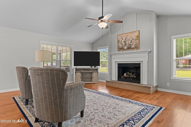 1139 Cranes Creek Rd, Cameron, NC 28326 - living area with ceiling fan, light wood-style flooring, a fireplace with raised hearth, baseboards, and high vaulted ceiling