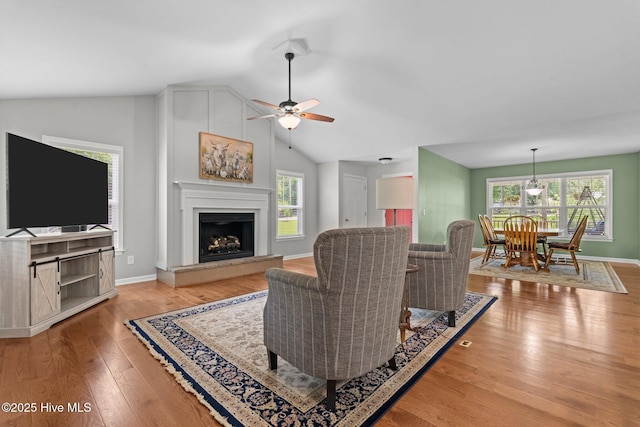 1139 Cranes Creek Rd, Cameron, NC 28326 - living room featuring a ceiling fan, lofted ceiling, plenty of natural light, light wood-style flooring, and a fireplace with raised hearth