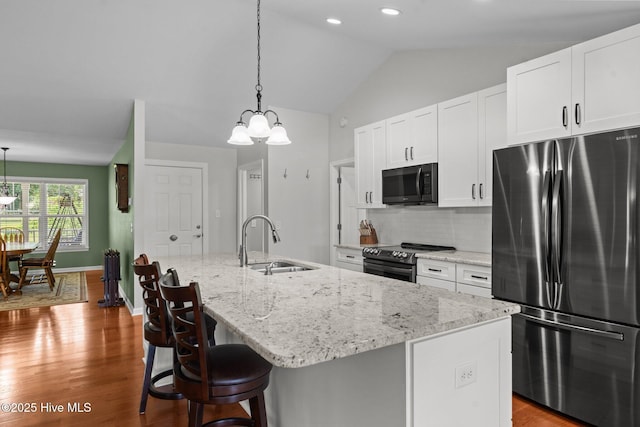1139 Cranes Creek Rd, Cameron, NC 28326 - kitchen featuring appliances with stainless steel finishes, a sink, a chandelier, white cabinets, and wood finished floors