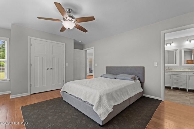 1139 Cranes Creek Rd, Cameron, NC 28326 - bedroom with wood finished floors, a closet, baseboards, ensuite bath, and a ceiling fan