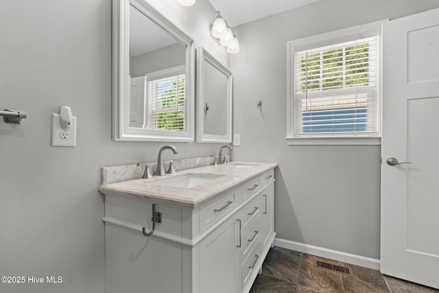 1139 Cranes Creek Rd, Cameron, NC 28326 - bathroom featuring baseboards, double vanity, and stone finish flooring