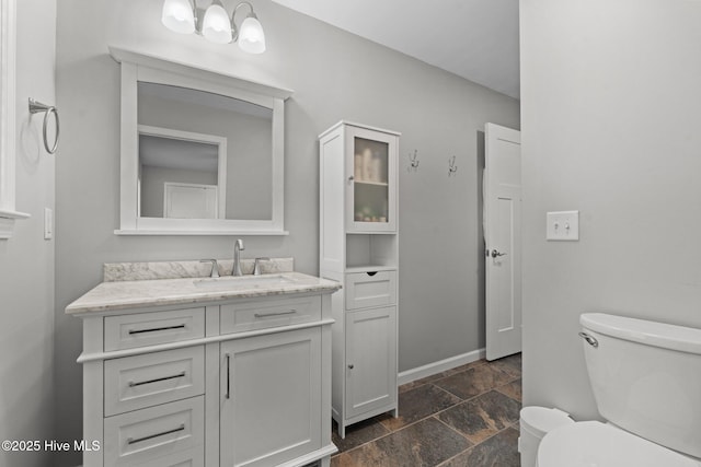 1139 Cranes Creek Rd, Cameron, NC 28326 - bathroom with stone tile flooring, toilet, vanity, and baseboards