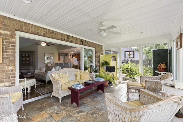 sunroom / solarium with a ceiling fan and outdoor lounge area
