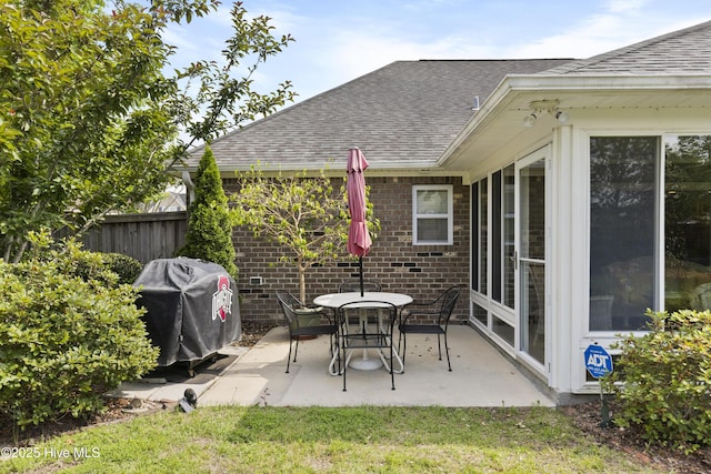 view of patio featuring a grill and fence
