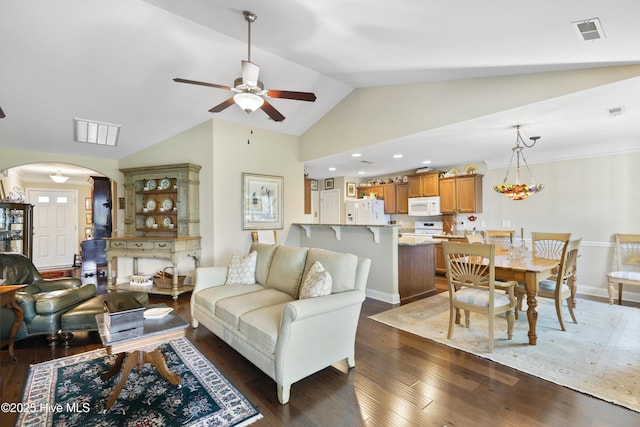 living room with arched walkways, ceiling fan, lofted ceiling, dark wood-type flooring, and recessed lighting