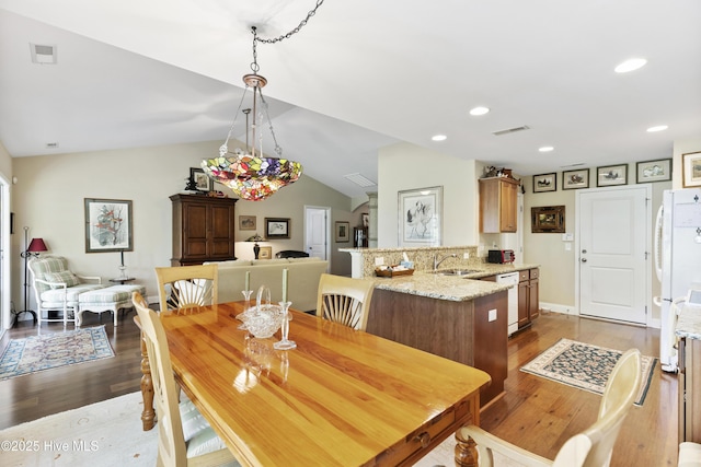 dining space featuring dark wood finished floors, lofted ceiling, and recessed lighting