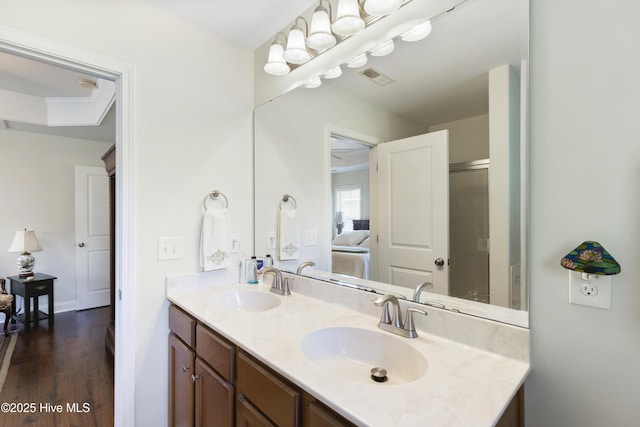 full bath featuring double vanity and wood finished floors