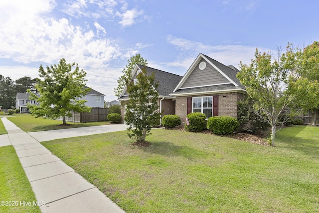 view of front of home featuring driveway, brick siding, and roof with shingles