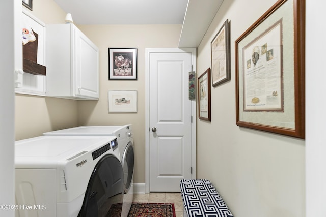 laundry area with independent washer and dryer, cabinet space, light tile patterned flooring, and baseboards