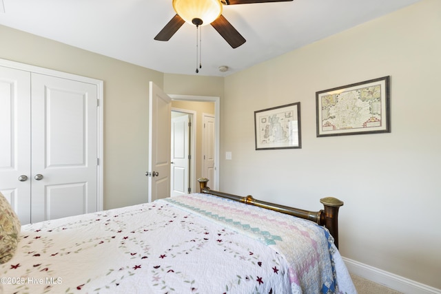 bedroom with a closet, baseboards, carpet flooring, and a ceiling fan