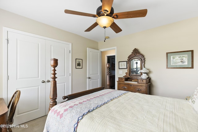 carpeted bedroom featuring a closet and a ceiling fan