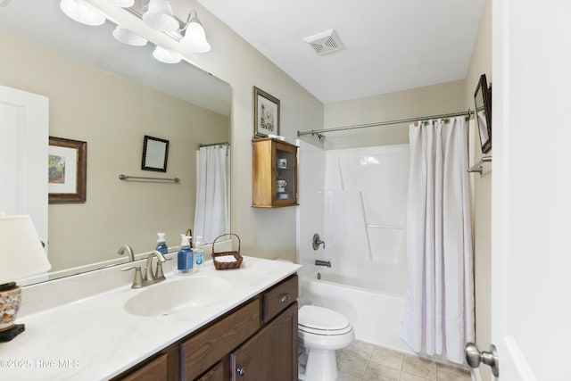 bathroom featuring toilet, vanity, shower / bath combo with shower curtain, and tile patterned floors