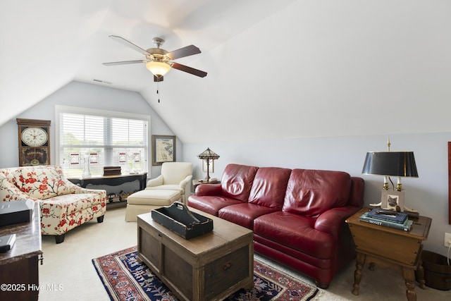 carpeted living area featuring a ceiling fan and lofted ceiling