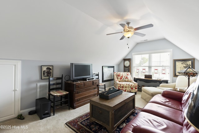 living room featuring light colored carpet, vaulted ceiling, ceiling fan, and baseboards