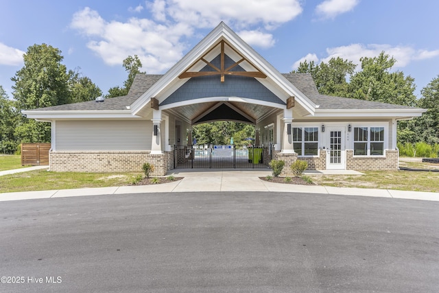 view of building exterior featuring fence and concrete driveway