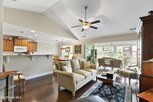 living room with a ceiling fan, vaulted ceiling, dark wood-type flooring, recessed lighting, and a chandelier