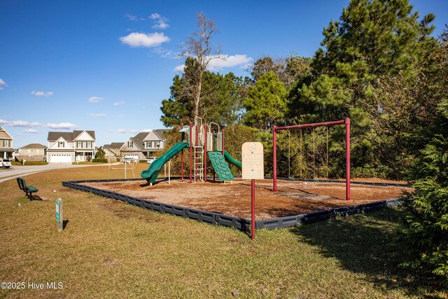 community play area featuring a yard and a residential view