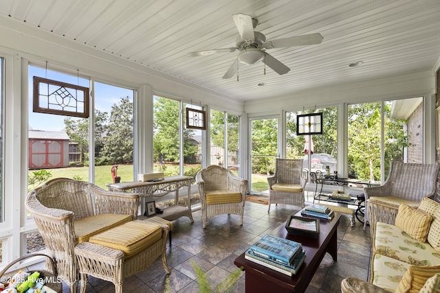 sunroom / solarium featuring an outdoor hangout area, healthy amount of natural light, and a ceiling fan