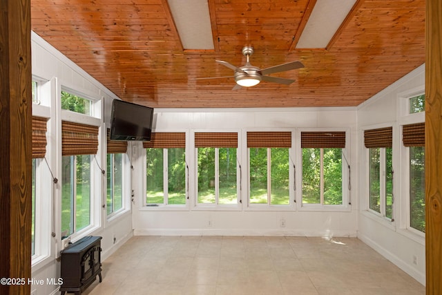 143 Rock Creek Dr, New Bern, NC 28562 - unfurnished sunroom with wooden ceiling, vaulted ceiling, baseboards, a skylight, and a wood stove
